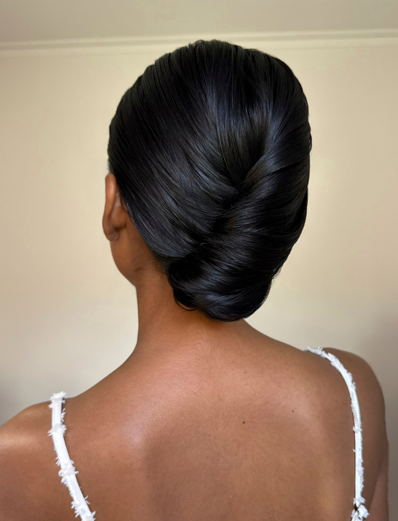 Sleek classic chignon updo on dark hair — Marikate Makeup Melbourne